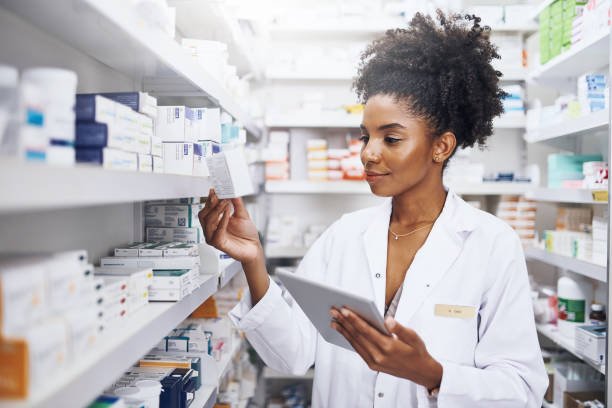 Pharmacist reviewing stock on a tablet